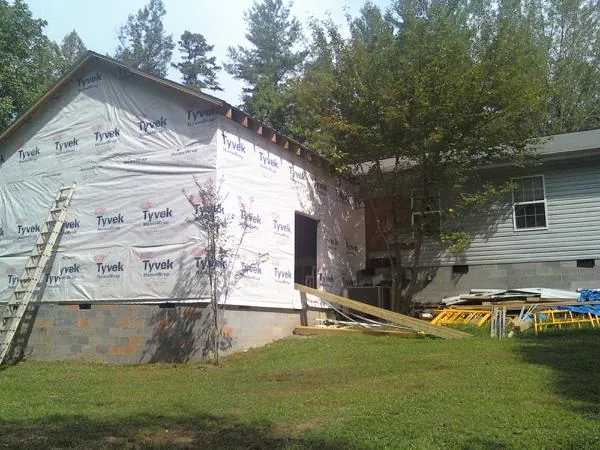 Tyvek wrapped gable on a new room addition beside an existing home in Salem